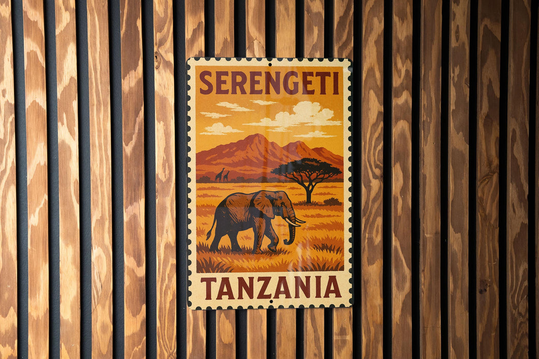 A vintage-style postage stamp from Tanzania featuring an elephant in a grassy field with mountains in the background.