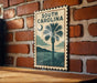 A framed poster of a palm tree and a beach scene hangs on a brick wall, with the text "SOUTH CAROLINA" prominently displayed.