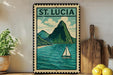 A framed illustration of St. Lucia, featuring a sailboat on the turquoise waters of the island, is displayed on a shelf next to a wooden cutting board and a potted plant.