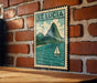 A vintage-style metal sign with a sailboat illustration and the text "ST. LUCIA" is displayed on a brick wall.