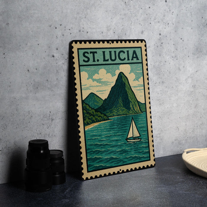 A framed illustration of St. Lucia, featuring a mountain landscape with a sailboat on the water, is displayed on a table.