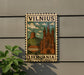 A vintage postage stamp depicting a castle and a hill in the background, with the text "VILNIS" and "Lithuania" printed on it.