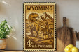 A Wyoming postage stamp featuring a dinosaur and a cowboy on a horse, with the text "Wyoming 4c U.S. Postage" printed on it.