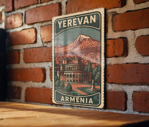 A vintage-style sign with the text "YEREVAN ARMENIA" is displayed on a brick wall, featuring an illustration of a cityscape with a mountain in the background.