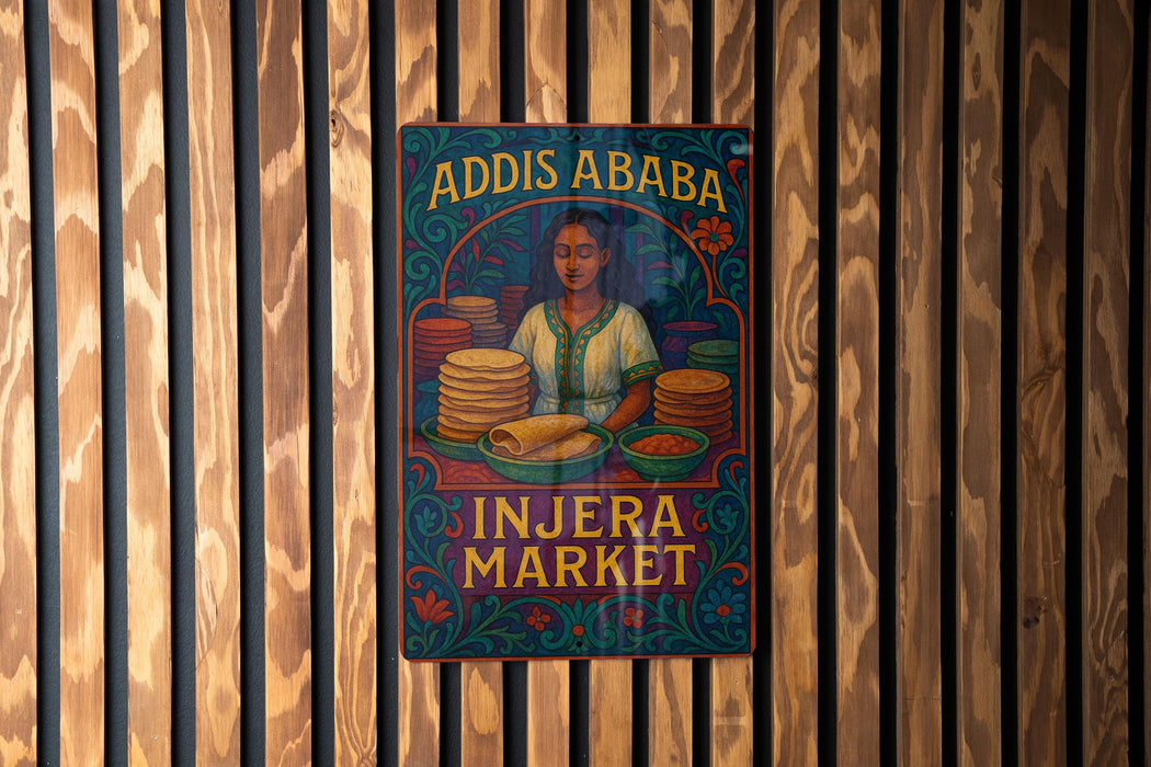 a colorful poster advertising an Injera Market, with a woman depicted in the center surrounded by stacks of bread.