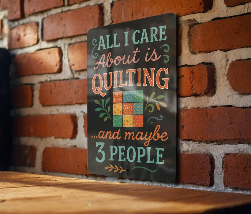 A sign with the text "All I care about is quilting...and maybe 3 people" is displayed on a brick wall.