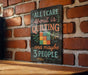 A sign with the text "All I care about is quilting...and maybe 3 people" is displayed on a brick wall.