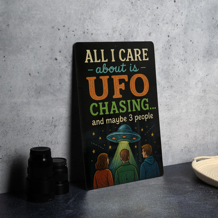 a sign with a humorous message about UFO chasing, accompanied by three cartoon characters.