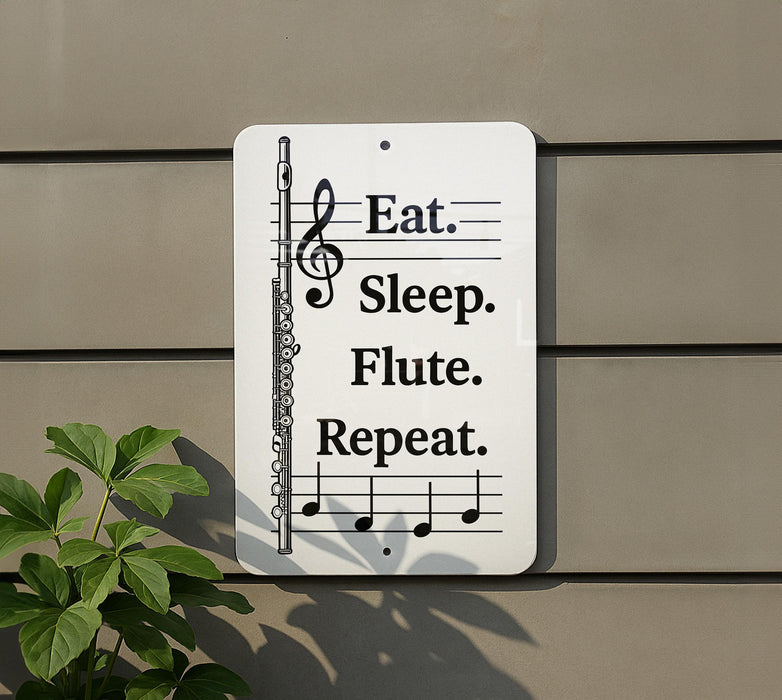 a sign with musical notes and a flute, accompanied by the text "Eat. Sleep. Flute. Repeat."