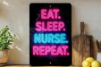 a neon sign with the text "EAT. SLEEP. NURSE. REPEAT." displayed on a black background.