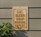 a sign with the message "EAT. SLEEP. SOAP-MAKING. REPEAT."