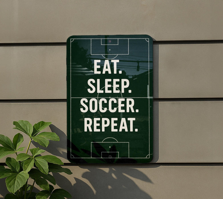a sign with the message "EAT. SLEEP. SOCCER. REPEAT." displayed on a wall.