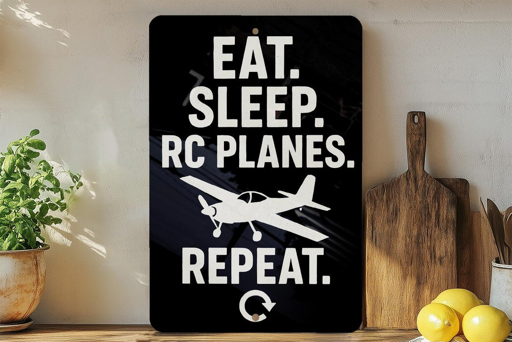 a sign with the text "EAT. SLEEP. RC PLANES. REPEAT." along with a graphic of a small airplane.