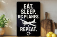 a sign with the text "EAT. SLEEP. RC PLANES. REPEAT." along with a graphic of a small airplane.