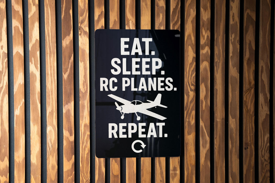 a sign with the text "EAT. SLEEP. RC PLANES. REPEAT." and a graphic of a small airplane.