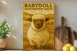 a large metal sign with a sheep illustration, placed on a wooden shelf next to a wooden cutting board and some lemons.