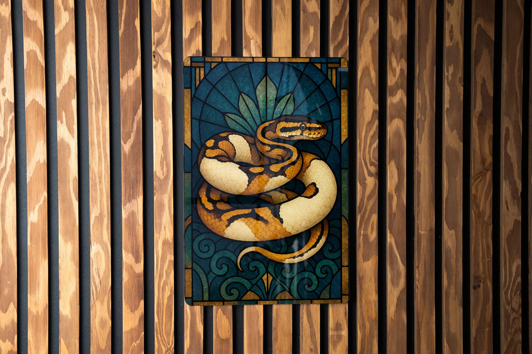 A stained glass artwork depicting a colorful snake is displayed on a wooden wall.