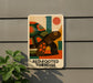 A sign with a colorful illustration of a red-footed tortoise on a wall, with the text "RED-FOOTED TORTOISE" below the image.