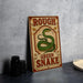 a vintage-style sign with the text "ROUGH GREEN SNAKE" and an illustration of a green snake.