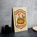 a sign for a bakery called "Sour Dough Bakery", with a loaf of bread and wheat stalks as the main design elements.