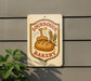 a sign for a bakery, with a bread loaf and wheat stalks as the main decorative elements.