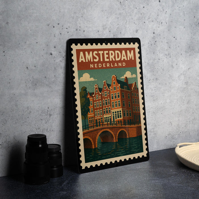 A framed poster of Amsterdam, Netherlands, featuring a colorful illustration of the city's iconic buildings and a bridge.