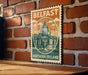 A vintage-style metal sign with the text "BELFAST NORTHERN IRELAND" and an illustration of a building, likely representing the capital city of Northern Ireland.