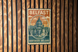 A vintage postage stamp from Belfast, Northern Ireland, featuring an illustration of the city's iconic architecture.