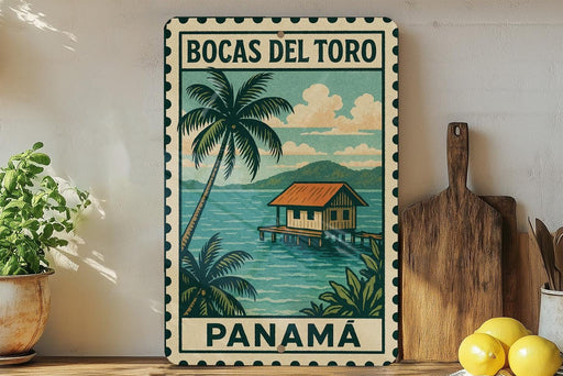 A vintage-style metal sign with a tropical island scene, featuring a wooden hut, palm trees, and a body of water. The sign is framed with a border and displays the text "BOCAS DEL TORO PANAMA".