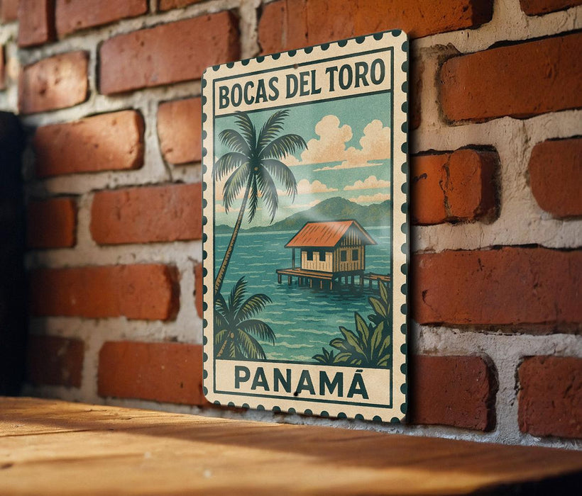 A vintage-style poster of Bocas del Toro, a tropical island in Panama, is displayed on a brick wall.