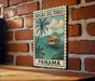 A vintage-style poster of Bocas del Toro, a tropical island in Panama, is displayed on a brick wall.