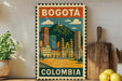 A vintage-style poster of Bogotá, Colombia, featuring a colorful illustration of the cityscape with buildings, a church, and a mountain in the background.