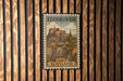A vintage-style metal stamp depicting the Edinburgh Castle in Scotland, with the text "EDINBURGH SCOTLAND" prominently displayed.