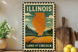 A vintage-style metal sign depicting the state of Illinois, with a landscape of fields and mountains in the background.