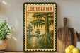 A framed illustration of a Louisiana bayou scene, featuring a large cypress tree with hanging roots, surrounded by other trees and a body of water.