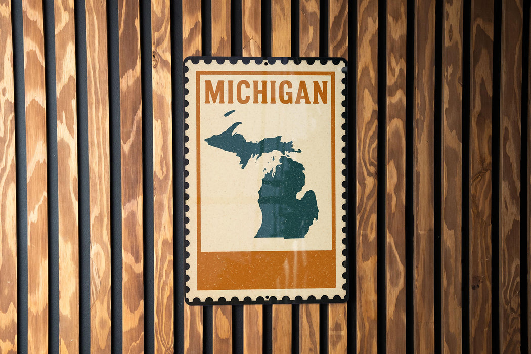 A vintage-style Michigan postage stamp is displayed on a wooden wall.