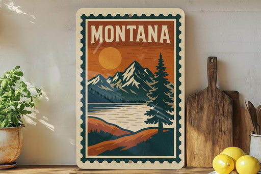 A vintage-style poster of Montana mountains and a lake, featuring a pine tree and a sunset, is displayed on a wall next to a wooden cutting board and a potted plant.