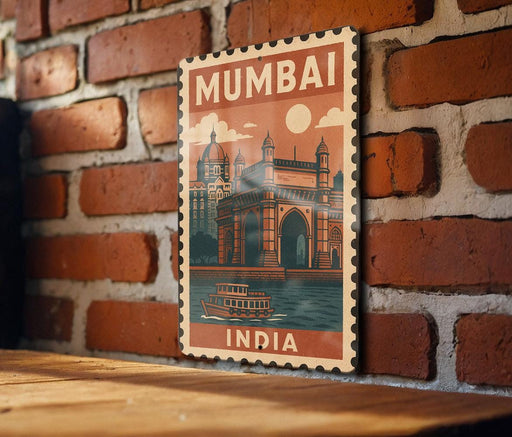 A vintage-style poster of the Mumbai skyline, featuring the iconic Gateway of India, is displayed on a brick wall.