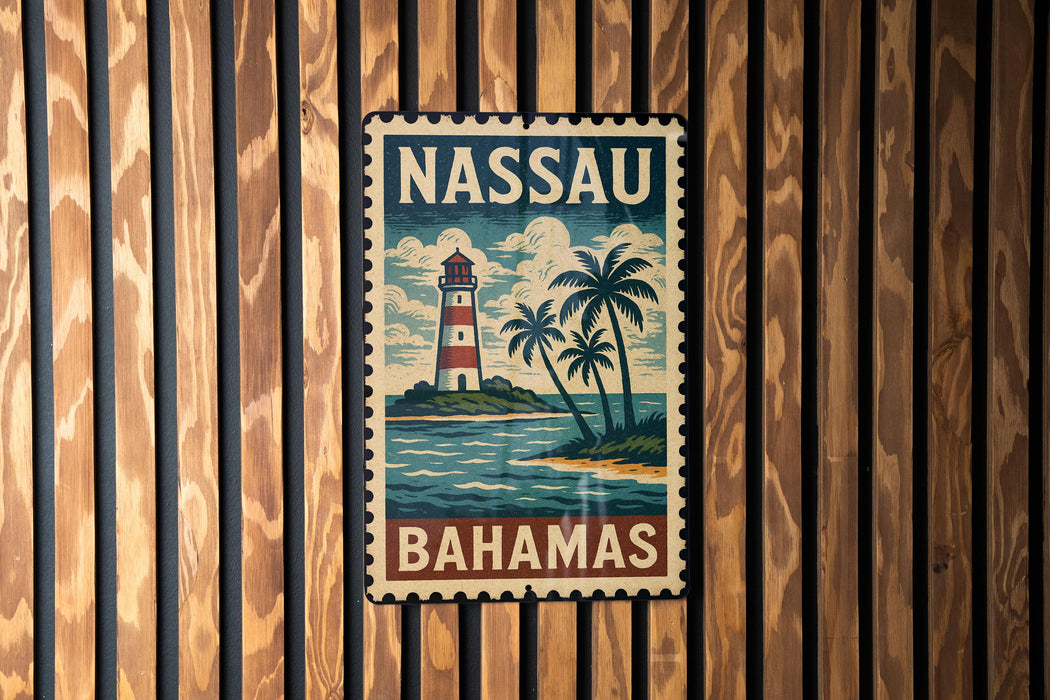 A vintage-style metal sign with the text "NASSAU BAHAMAS" and an illustration of a lighthouse and palm trees, mounted on a wooden wall.