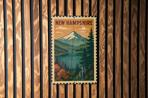 A vintage-style postage stamp depicting a scenic landscape with a mountain, lake, and pine trees, hanging on a wooden wall.