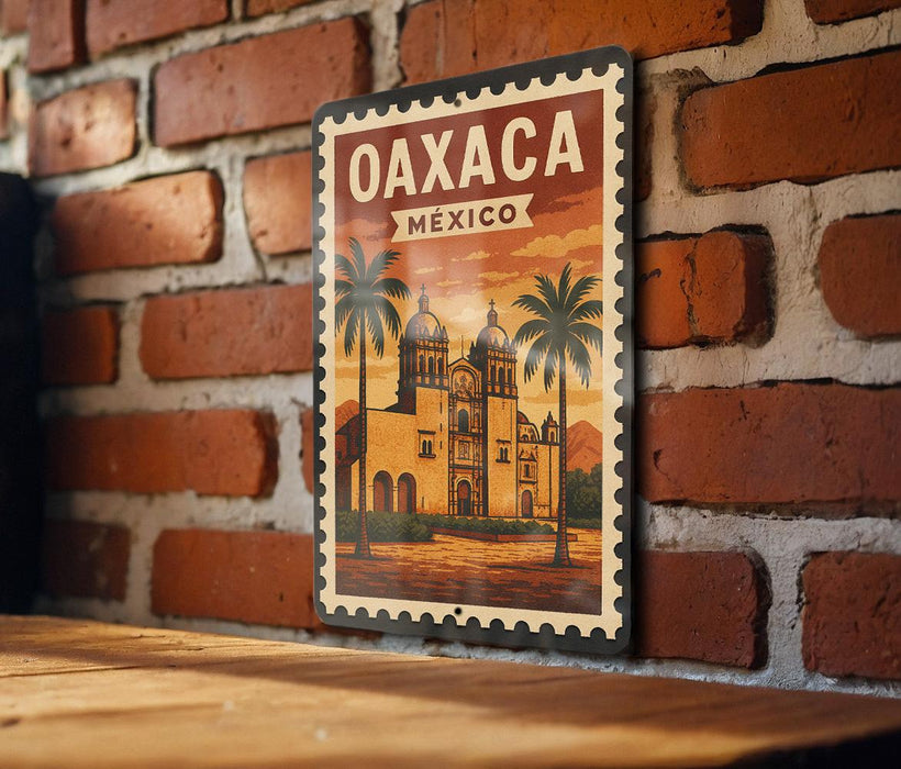 A vintage-style poster of Oaxaca, Mexico, featuring a brick wall and palm trees, is displayed on a wooden surface.