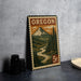 A framed print of a mountain landscape with a river, featuring the word "OREGON" and a 5 cent denomination, is displayed on a table.