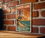 A vintage-style poster of Puna Cana, the Dominican Republic, is displayed on a brick wall.