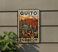 A metal sign with a vintage-style illustration of Quito, Ecuador, featuring a mountain and a cityscape.