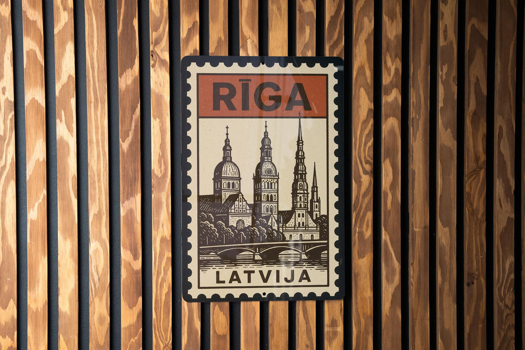 A vintage-style postage stamp from Latvia featuring a cityscape with a bridge and a church, mounted on a wooden wall.