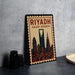 A framed poster of the skyline of Riyadh, Saudi Arabia, featuring the city's iconic landmarks and architecture.