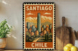 A vintage-style metal sign with the text "SANTIAGO CHILE" displayed prominently, featuring an illustration of a cityscape with mountains in the background.