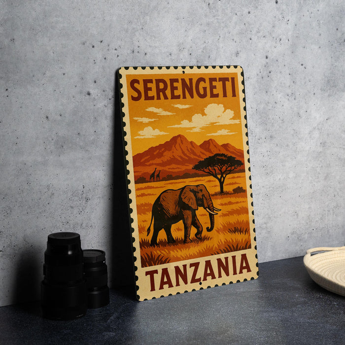 A metal sign with a vintage-style illustration of an elephant and a landscape, along with the text "SERENGETI TANZANIA".