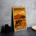 A metal sign with a vintage-style illustration of an elephant and a landscape, along with the text "SERENGETI TANZANIA".