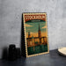 A metal sign with a vintage-style illustration of the city of Stockholm, Sweden, featuring landmarks such as the Royal Palace and the St. Peter's Basilica.